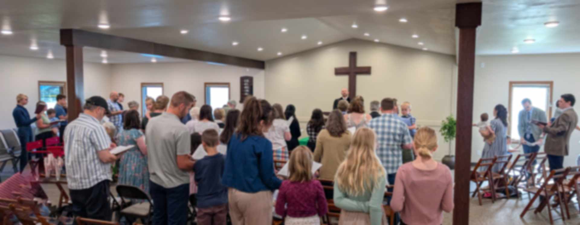 Reformation Presbyterian Church congregation standing in worship before the cross